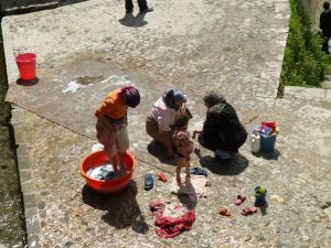 Washing rugs in the sun